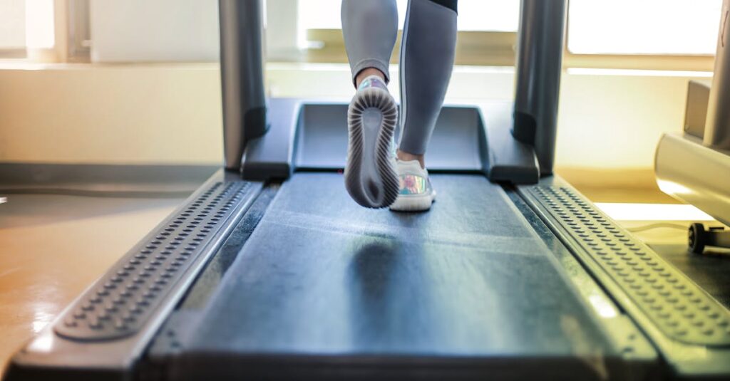 Close-up shot of a person exercising on a treadmill, showcasing fitness and health focus.